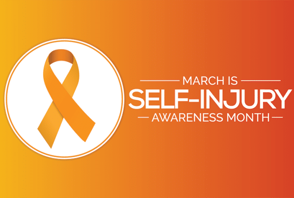 Self-Injury Awareness Month poster featuring white text on a yellow and orange background.