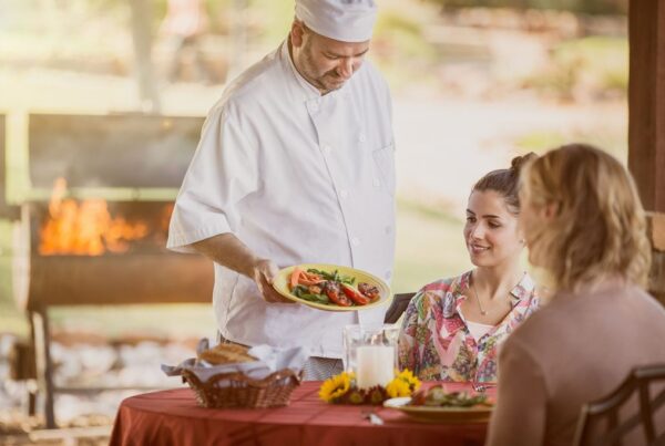 Chef at Enterhealth Ranch inpatient rehab presenting patient with delicious plate of food.