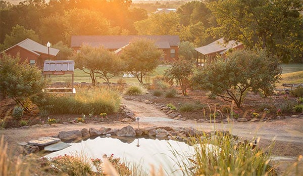 Reflecting pond, walkways and cabins at Enterhealth Ranch inpatient treatment center.